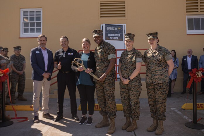 U.S. Marine Corps Brig. Gen. James A. Ryans II, commanding general of Marine Corps Recruit Depot San Diego, center, and U.S. Marines and members of Marine Corps Community Service, pose for a group photo after the ribbon cutting ceremony to officially open a new 24-hour Marine Corps Exchange at Basic Recruiter School on Marine Corps Recruit Depot San Diego, March 19, 2024. The Marine Corps is opening 24-hour self-service stores in efforts to modernize the force and to provide service to the Marines at any time. (U.S. Marine Corps photo by Lance Cpl. Alexandra M. Earl)