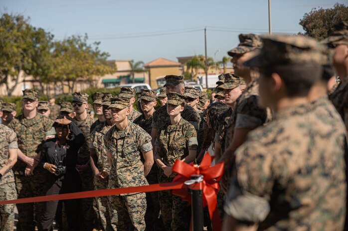 U.S. Marines and civilians at Marine Corps Recruit Depot San Diego await the ribbon cutting ceremony to officially open a new 24-hour Marine Corps Exchange at Basic Recruiter School on Marine Corps Recruit Depot San Diego, California, March 19, 2024. The Marine Corps is opening 24-hour self-service stores in efforts to modernize the force and to provide service to the Marines at any time. (U.S. Marine Corps photo by Lance Cpl. Alexandra M. Earl)