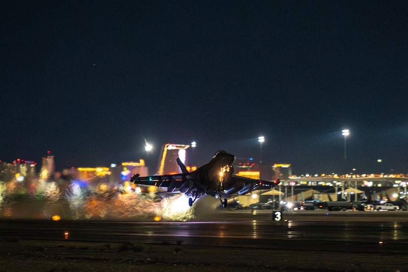 A jet takes off at night.