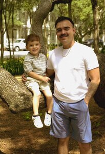 U.S. Air Force Senior Airman Andy Soto, a 1st Special Operations Force Support Squadron fitness specialist, spends time with his son at Grayton Beach. Soto has utilized base resources such as the Child Development Center and Family Care Program to help him balance being a single father and an Airman. (Courtesy photo)