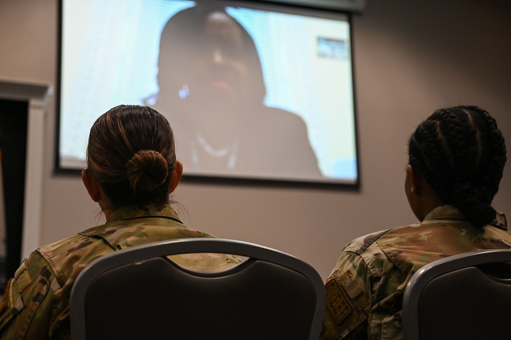 U.S. Air Force Senior Master Sgt. Crystal Doepker, 17th Comptroller Squadron senior enlisted leader, left, and Staff Sgt. Crystyle Caviness-Jules, 17th Communications Squadron project manager, right, sit in the audience listening to the keynote speaker, Ret. U.S. Army Maj. Dalmyra Price Caesar, White House Personnel deputy director, during the 17th Training Wing Women’s History Month Panel at the Powell Event Center, Goodfellow Air Force Base, Texas, March 26, 2024. The panel consisted of six women from around the 17th Training Wing, facilitating a platform to share their experiences, motivations and the barriers they have broken throughout their careers. (U.S. Air Force photo by Airman 1st Class Evelyn J. D’Errico)