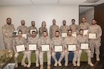 Maj. Gen. Fahad AL-Julaihim, Royal Saudi Air Force, Air Force Training, deputy director (2nd row, center), and U.S. Air Force Col. Casey Pombert (2nd row, 4th from left), Air Force Security Assistance and Training commander, pose for a group photo with the graduating cohort at the Electronic Warfare Course graduation Mar. 5, 2024 at Joint Base San Antonio, Texas. The electronic warfare course entailed more than three and a half years of training consisting of 4,400 hours of instruction, including thirty-four courses, several exercises, and simulations. (U.S. Air Force Photo by Andrew C. Patterson)