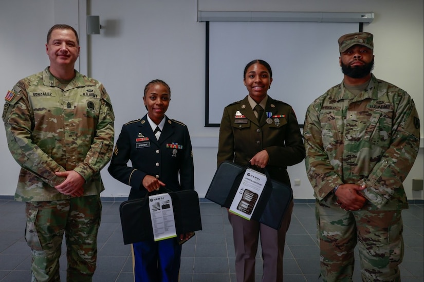 Four soldiers pose for a photo.