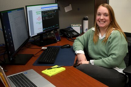 Whitney Hartwell, Redstone Arsenal Army Military Pay Office military pay technician, who is married to U.S. Army Capt. Joshua Hartwell, assistant project manager for acquisitions at the Army Program Executive Office Missiles and Space, poses for a photo in the AMPO at Redstone Arsenal, Alabama, March 26, 2024. A recent U.S. Army Financial Management Command initiative ensures AMPO employees who relocate with their service member spouses during permanent changes of station will maintain their positions within the command. (U.S. Army photo by Eric Schultz)