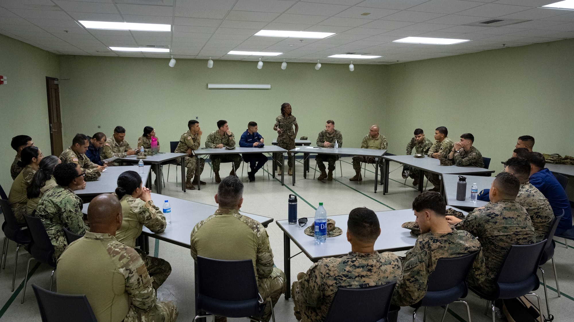 U.S. Marine Corps Capt. Aneesah Akbar-Uqdah, the
commanding officer assigned to Det. 1 Landing Support Company, Combat Logistics Regiment 45, 4th Marine Logistics Group, Marine Corps Reserve, briefs service members deliver a mission briefing to servicemembers in preparation for a joint training non-commissioned officer leadership field exercise, Ceiba, Puerto Rico, March 15, 2024. The exercise included service members with the Puerto Rico Air National Guard, Marine Corps Reserve, Army Reserve, Navy Reserve, and Coast Guard Reserve, which allowed participants to develop leadership skills, such as survivability, adaptability, and conflict response during a simulated humanitarian disaster response event. (U.S. Air National Guard photo by 2nd Lt. Eliezer Soto)