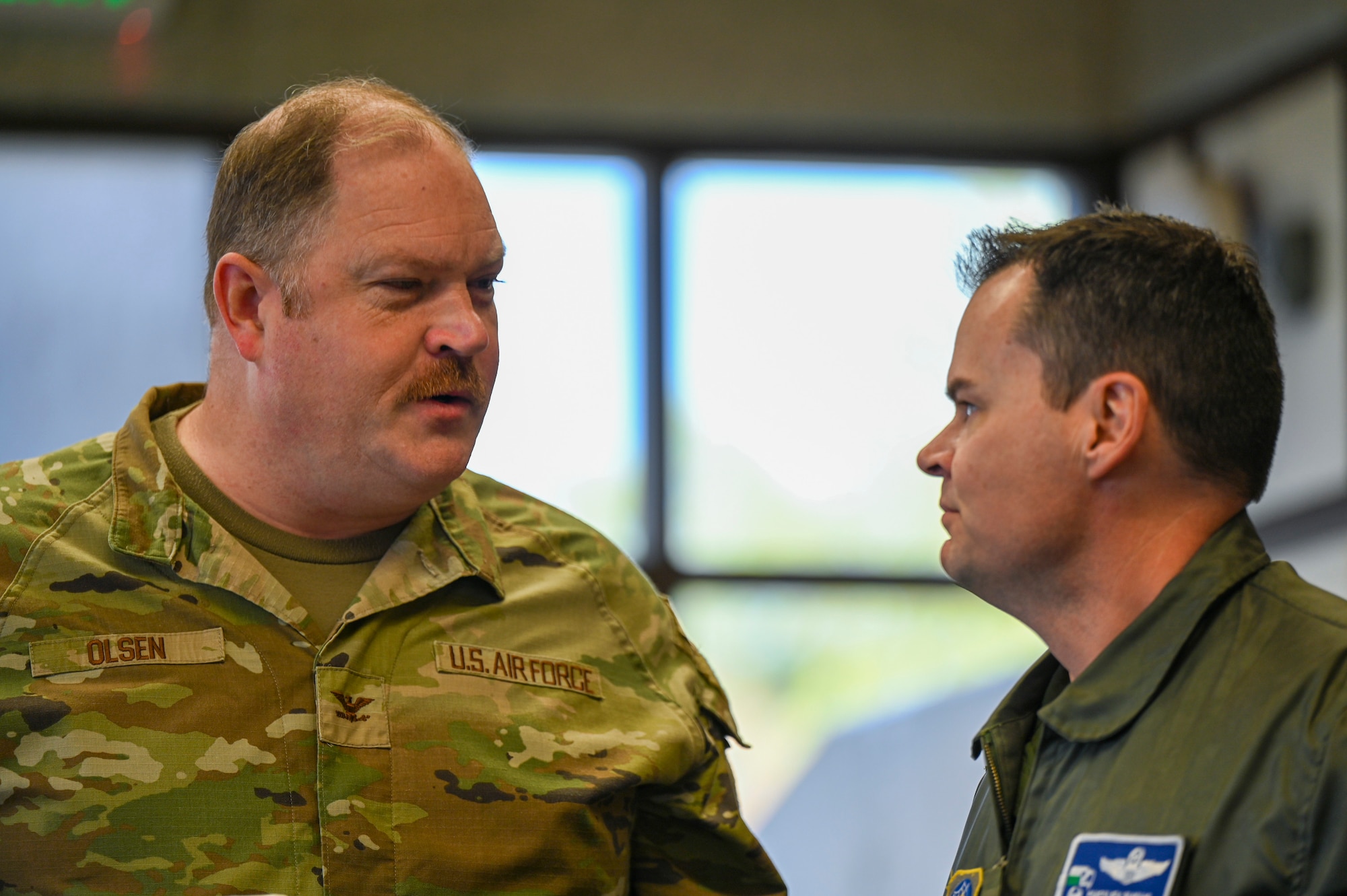 Two military members talk.