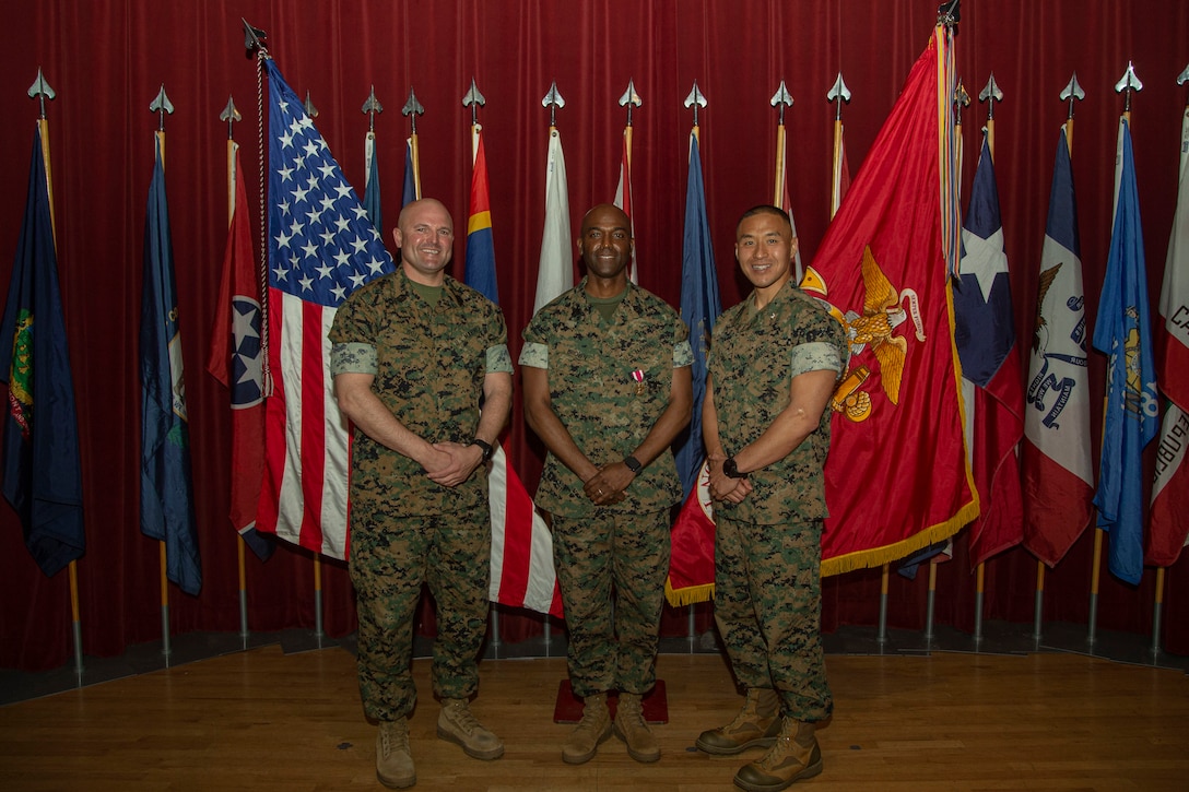 U.S. Marine Corps Sgt. Maj. Trevor L. Goff, oncoming sergeant major of I Marine Expeditionary Force Support Battalion, I Marine Expeditionary Force Information Group, left, Sgt. Maj. Lynn D. Brown, outgoing sergeant major of I MSB, I MIG, and Lt. Col. John Shim, commanding officer of I MSB, I MIG, right, pose for a photo during a relief and appointment ceremony at Marine Corps Base Camp Pendleton, California, Mar 25, 2024. The relief and appointment ceremony represents the official passing of responsibilities from one senior enlisted leader to another. Goff and Brown are both natives of Michigan. (U.S. Marine Corps photo by Lance Cpl. Ricardo Ramirez)