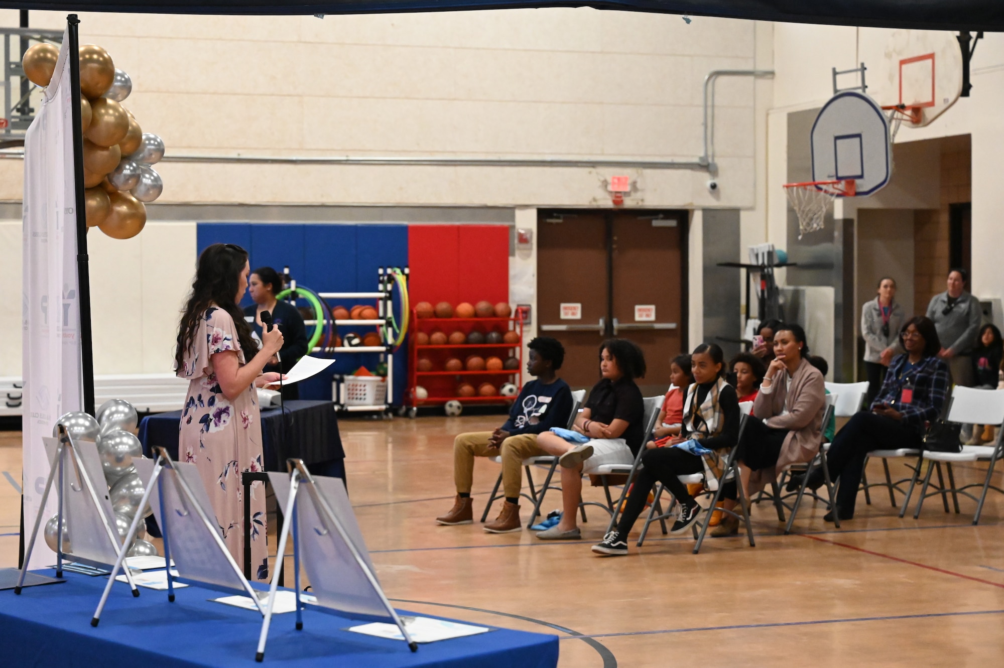 Woman speaks in front of an audience.