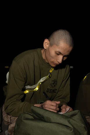 U.S. Marine Corps Recruit Jason Yazzie with Bravo Company, 1st Recruit Training Battalion, labels his gear during receiving at Marine Corps Recruit Depot San Diego, California, March 25, 2024. During the receiving process recruits are checked for contraband, given haircuts, make phone calls home, and are issued gear. (U.S. Marine Corps photo by Lance Cpl. Janell B. Alvarez)