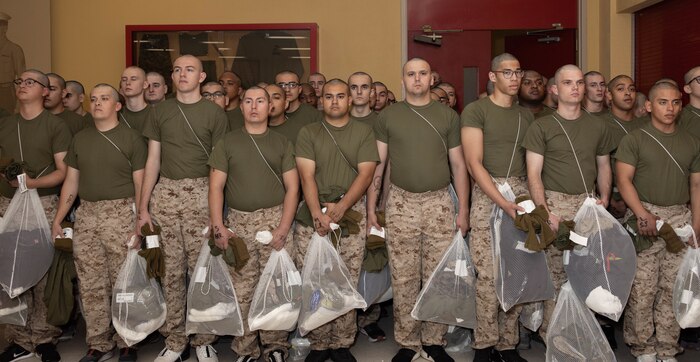 U.S. Marine Corps recruits with Bravo Company, 1st Recruit Training Battalion, wait to receive gear during the receiving process at Marine Corps Recruit Depot San Diego, California, March 25, 2024. During the receiving process recruits are checked for contraband, given haircuts, make phone calls home, and are issued gear. (U.S. Marine Corps photo by Lance Cpl. Janell B. Alvarez)