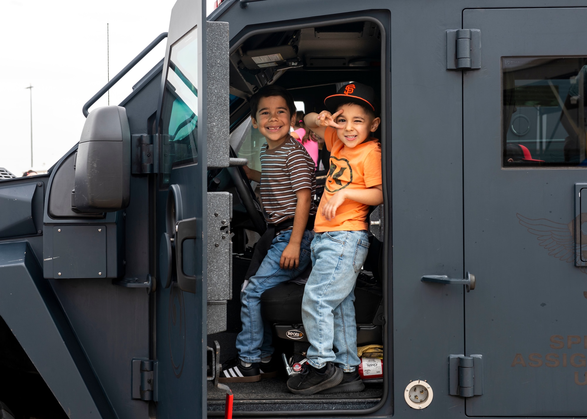 Two children pose inside a Glendale Police Department Special Weapons and Tactics armored vehicle March 23, 2024, at Luke Air Force Base, Arizona.