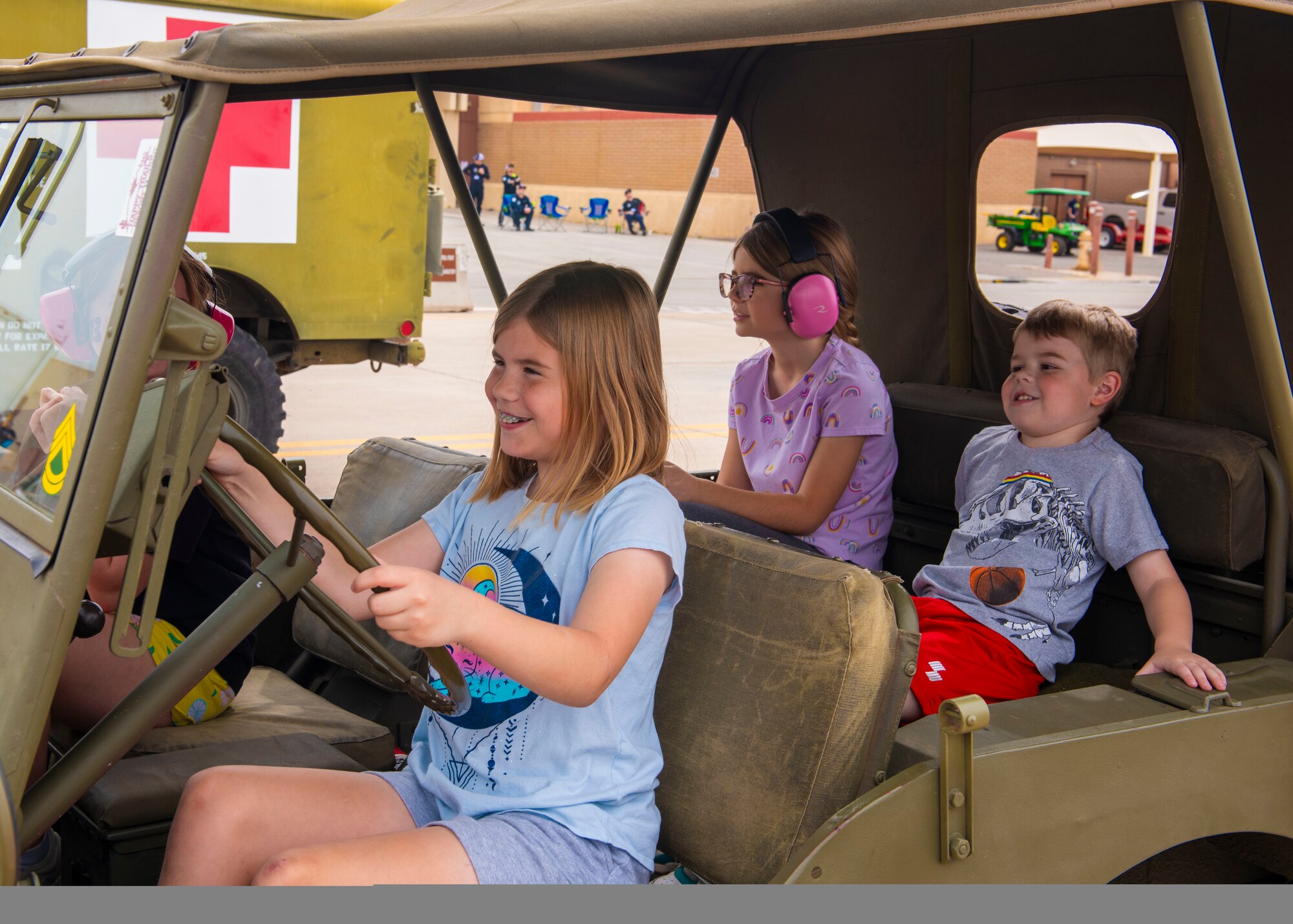 Four military children pretend to drive a World War II 1943 Ford GPW Jeep contributed by the Lt. Frank Luke Museum Jr. March 23, 2024, at Luke Air Force Base, Arizona.