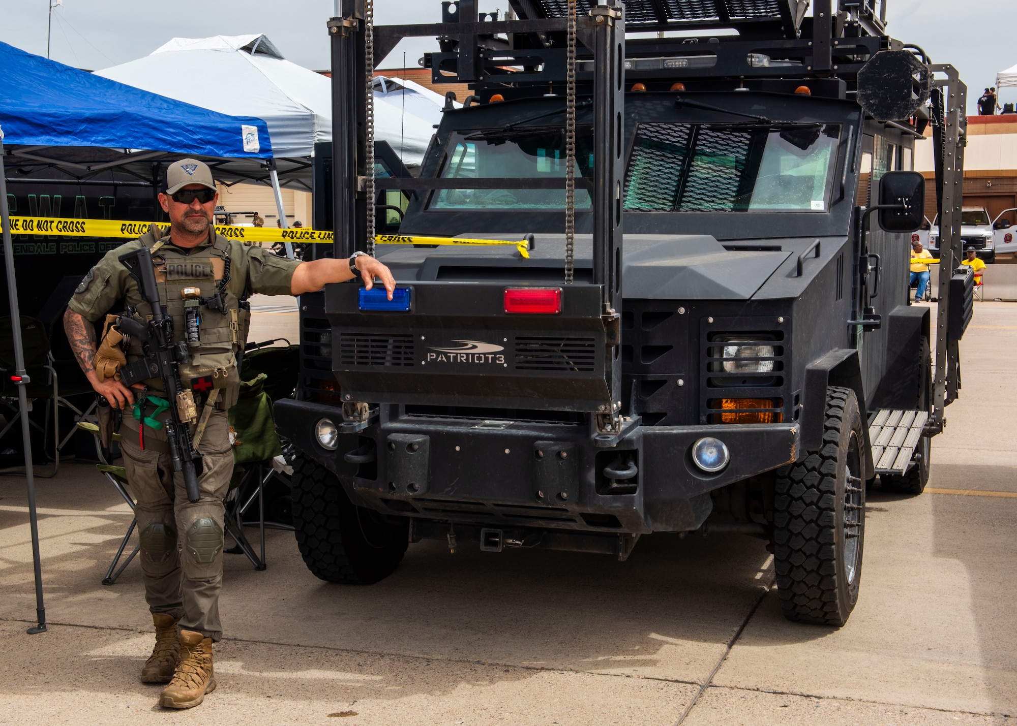 Robert Solis, Glendale Police Department firearms training and consulting instructor, leans against a Special Weapons and Tactics vehicle March 23, 2024, at Luke Air Force Base, Arizona.