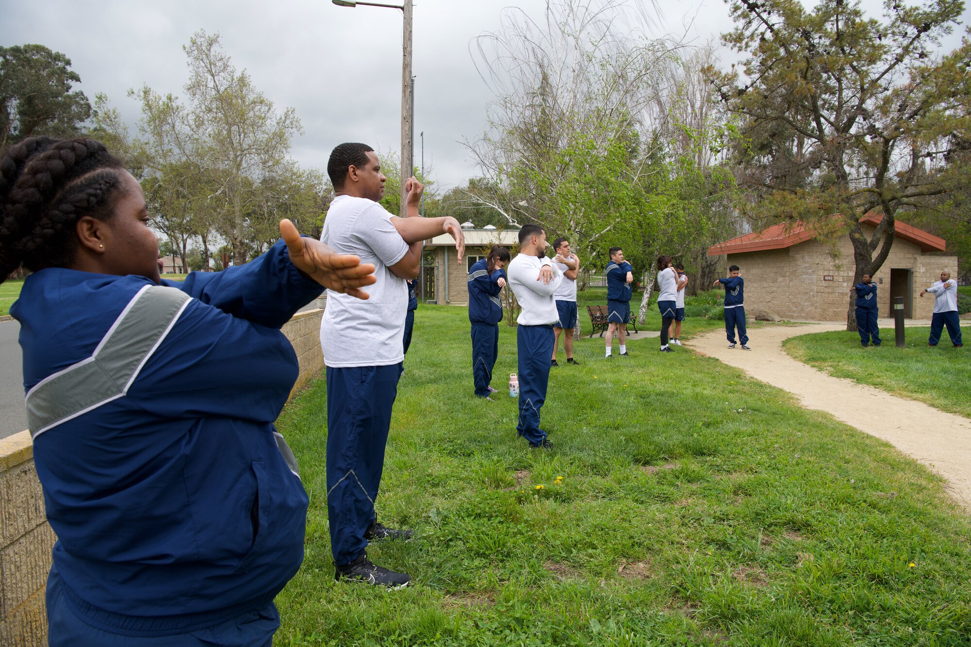 Airmen at Travis AFB start with stretches to prepare for the track.