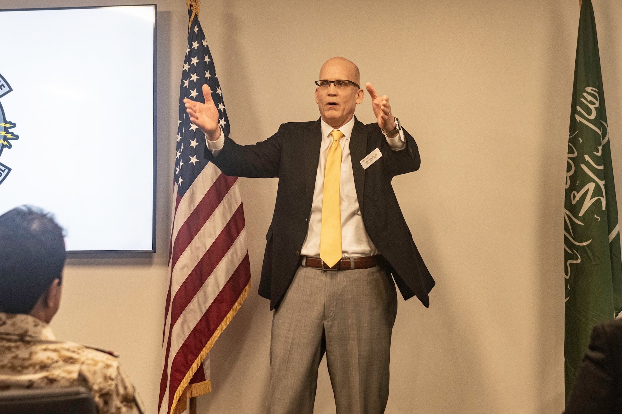 male speaker standing in front of a room