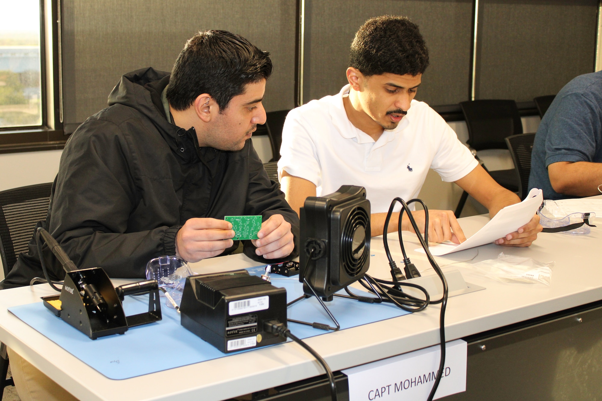 two male students working at a table