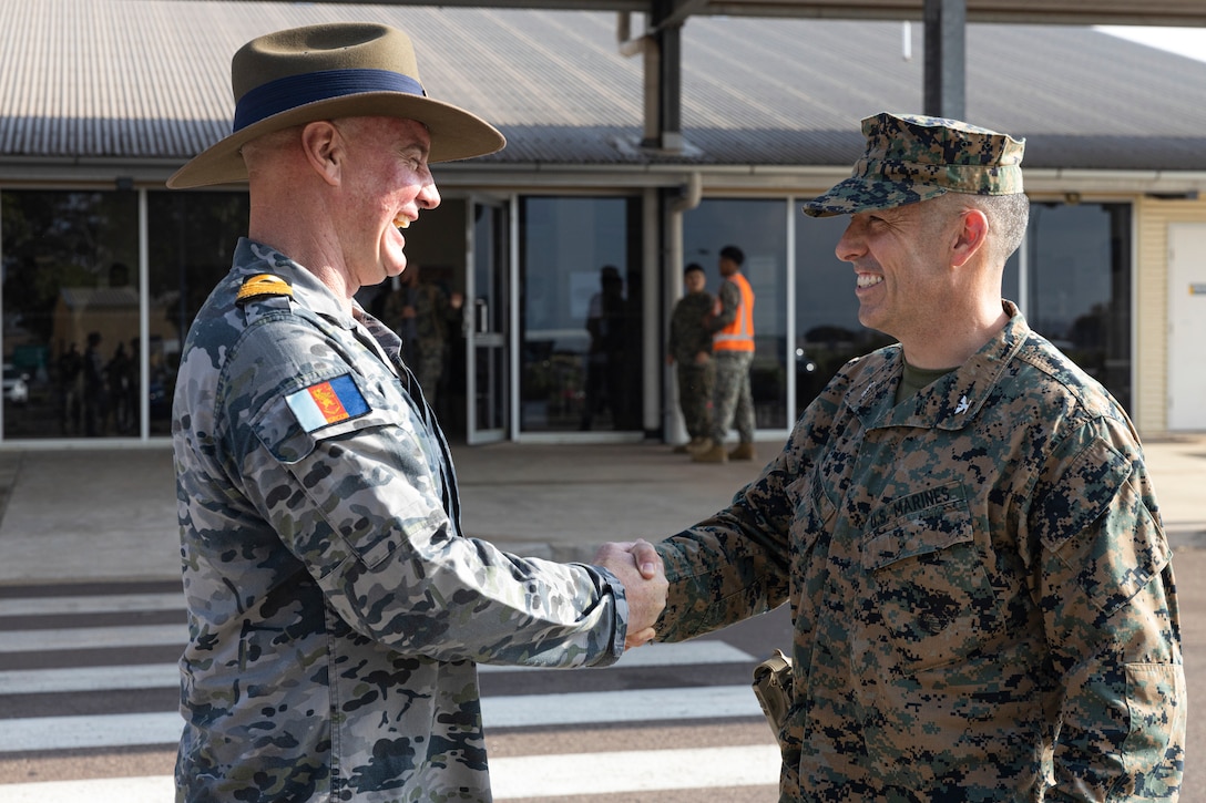 U.S. Marine Corps Col. Brian Mulvihill, right, the commanding officer of Marine Rotational Force – Darwin 24.3, shakes hands with Royal Australian Navy Capt. Mitchell Livingstone, the commanding officer of Headquarters Northern Command at Royal Australian Air Force Base Darwin, NT, Australia, March 24, 2024. MRF-D 24.3 is part of an annual six-month rotational deployment to enhance interoperability with the Australian Defence Force and Allies and partners and provide a forward-postured crisis response force in the Indo-Pacific. Mulvihill is a native of New York. (U.S. Marine Corps photo by Sgt. Cristian L. Bestul)