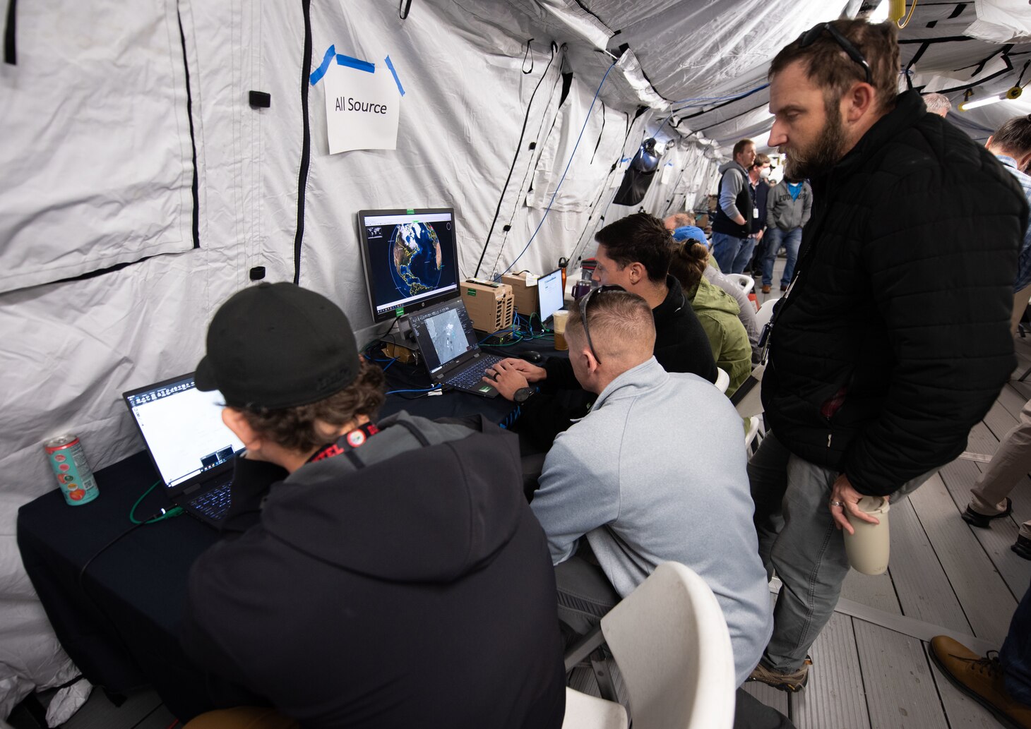 Subject matter experts and distinguished visitors participate in the System of Systems Naval Integration Experiment at NIWC Atlantic.