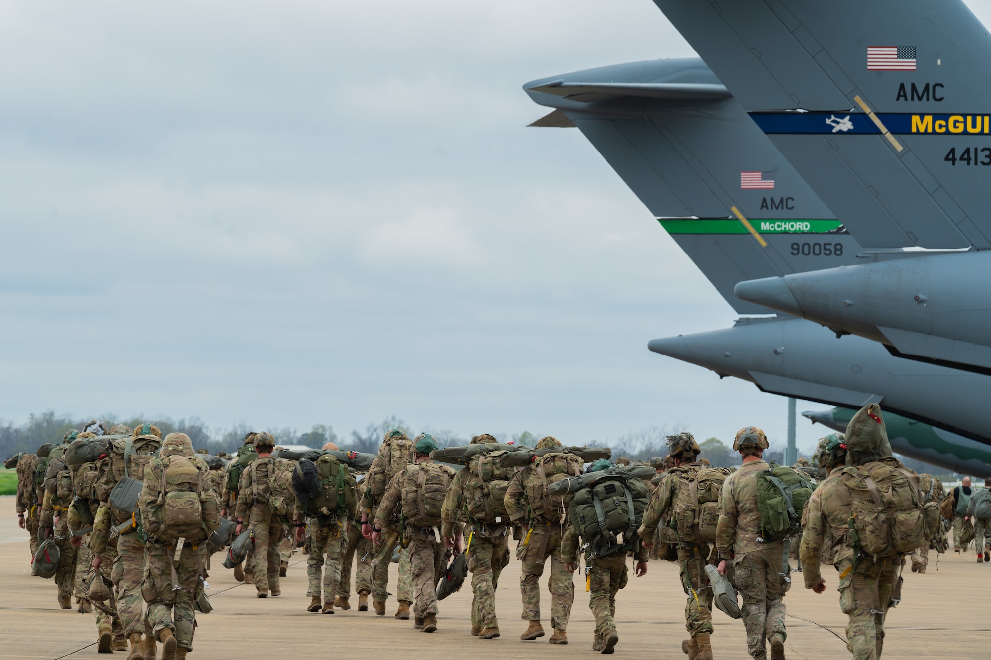 Soldiers prepare to board C-17s