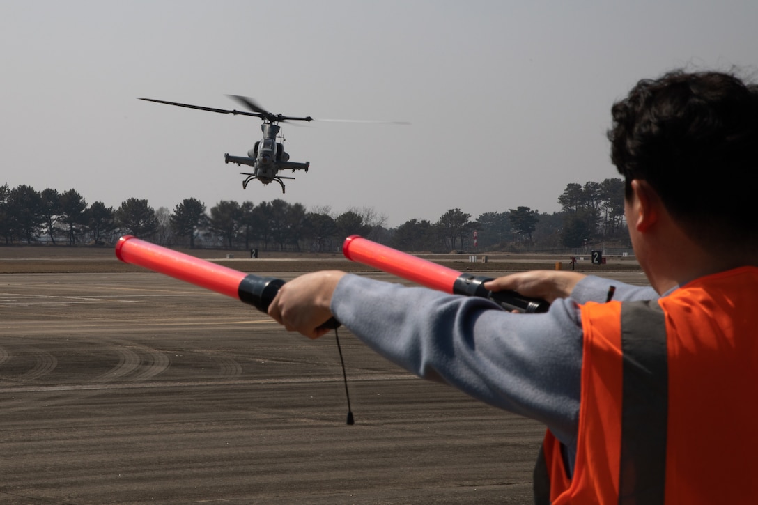 U.S. Marine Corps UH-1 Y Venom Huey helicopter, with Marine Light Attack Helicopter Squadron (HMLA) 369, Marine Aircraft Group 36, 1st Marine Aircraft Wing, is guided to land, at Nosan Air Base, Republic of Korea, March 14, 2024. MARFORK emphasizes the importance of constant communication between allied forces, in order to commit to a stronger, more knowledgeable and efficient fighting force across the globe.