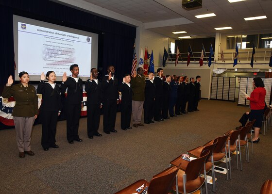 JOINT BASE SAN ANTONIO-FORT SAM HOUSTON – (March 27, 2024) – Immigration Service Officer Yoli Fleming administers the Oath of Allegiance to 15 service members from the U.S. Army, Navy, and Air Force who became U.S. citizens from the countries of China, Kenya, Jamaica, Nigeria, Vietnam, Venezuela, and The Philippines during a U.S. Citizenship Naturalization Oath Ceremony held at the Military and Family Readiness Center.  The keynote address was delivered by Navy Nurse Capt. Jennifer Buechel, of Woodhaven, Mich., commanding officer, Naval Medical Research Unit (NAMRU) San Antonio. NAMRU San Antonio’s mission is to conduct gap driven combat casualty care, craniofacial, and directed energy research to improve survival, operational readiness, and safety of Department of Defense (DoD) personnel engaged in routine and expeditionary operations. It is one of the leading research and development laboratories for the U.S. Navy under the DoD and is one of eight subordinate research commands in the global network of laboratories operating under the Naval Medical Research Command in Silver Spring, Md. (U.S. Navy photo by Burrell Parmer, NAMRU San Antonio Public Affairs/Released)