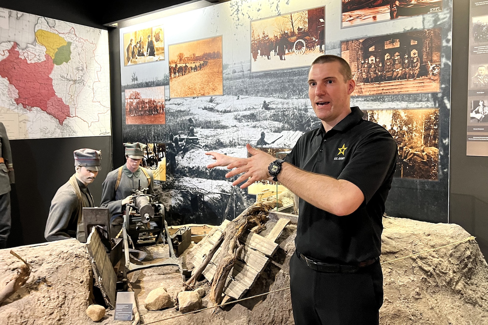 U.S. Army Staff Sgt. John Mateja, Pennsylvania National Guard, the religious affairs NCO of U.S. Army Garrison Poland, shows tour guests a visual of the battlefield at the Museum of the Wielkopolska Uprising of 1918-1919 in Poznan, Poland, March 15, 2024. Mateja guided U.S. Army Soldiers through this museum to see the artifacts and historical replicas that represent the Polish history of independence.