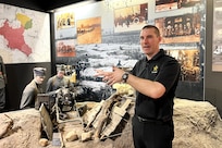 U.S. Army Staff Sgt. John Mateja, Pennsylvania National Guard, the religious affairs NCO of U.S. Army Garrison Poland, shows tour guests a visual of the battlefield at the Museum of the Wielkopolska Uprising of 1918-1919 in Poznan, Poland, March 15, 2024. Mateja guided U.S. Army Soldiers through this museum to see the artifacts and historical replicas that represent the Polish history of independence.