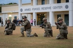 U.S. Airmen assigned to the 156th Tactical Advisory Squadron,  Puerto Rico Air National Guard, and a U.S. Soldier assigned to the 1st Mission Support Command, Army Reserve, assume defensive positions during a joint training noncommissioned officer leadership field exercise at Roosevelt Roads, Ceiba, Puerto Rico, March 15, 2024. The exercise included service members with the Puerto Rico Air National Guard, Marine Corps Reserve, Army Reserve, Navy Reserve, and Coast Guard Reserve.