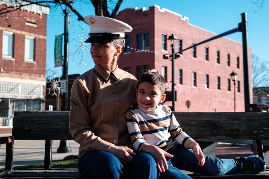 U.S. Marine Corps Pfc. Viktoriia Fedosova, the Company Honor Graduate with India Co., 3rd Recruit Training Battalion, and her son, Victor sit together on a bench in Sevierville, Tennessee, Feb. 15, 2023. The Marine Corps seeks to find and attract the Marine of tomorrow – a smarter, lifelong learner who meets our tough physical standards and understands that while we modernize equipment and tactics, our success depends on their ability to adapt to emergent threats in austere environments. Through her hard work, Fedosova proved that she has what it takes to be a United States Marine. (U.S. Marine Corps Photo by Cpl. Skyler Harris)