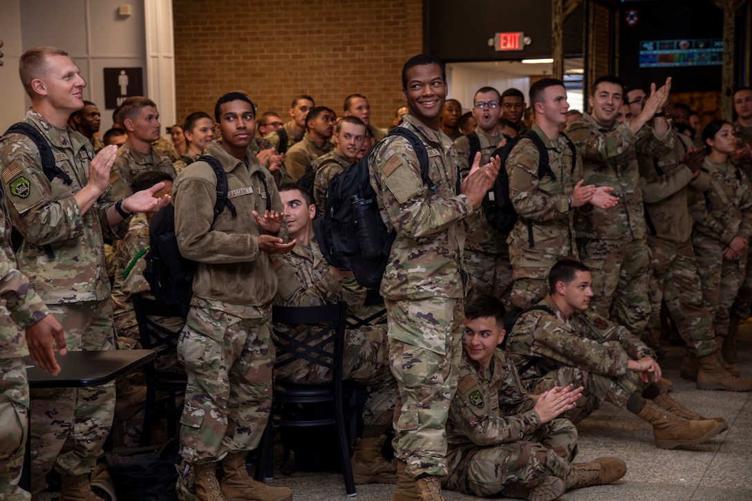 Airmen stand in a group during a function