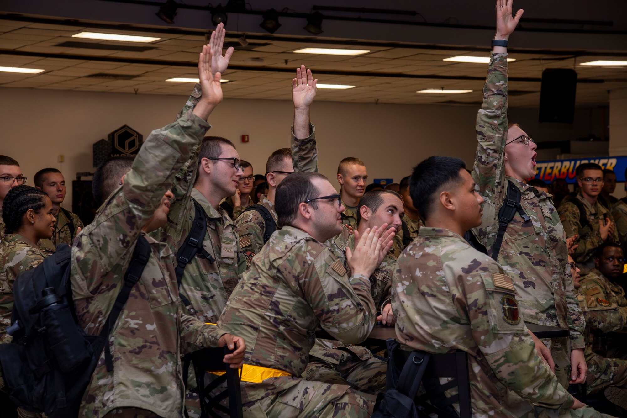 Airmen stand in a group during a function