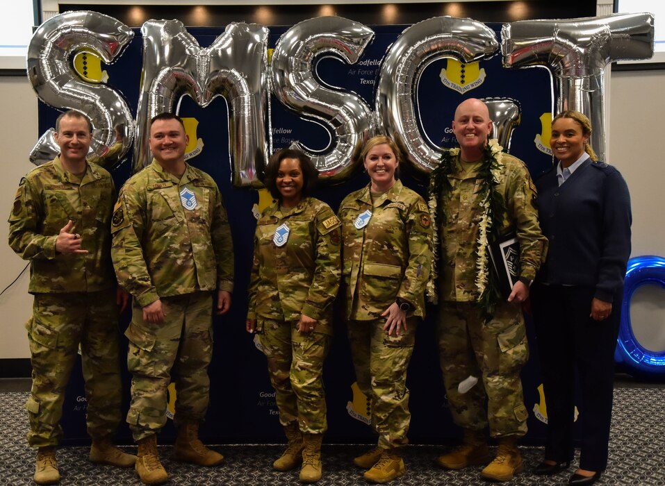 U.S. Air Force Col. Christopher Corbett, 17th Training Wing deputy commander, and                                     Chief Master Sgt. Khamillia Washington, 17th Training Wing command chief, pose with the Senior Master Sgt. selectees following the selectee's release party at the Powell Event Center, Goodfellow Air Force Base, Texas, March 25, 2023. This year, there were only 1,734 individuals selected out of 15,151 eligible. (U.S. Marine Corps photo by Cpl. Jessica Roeder)