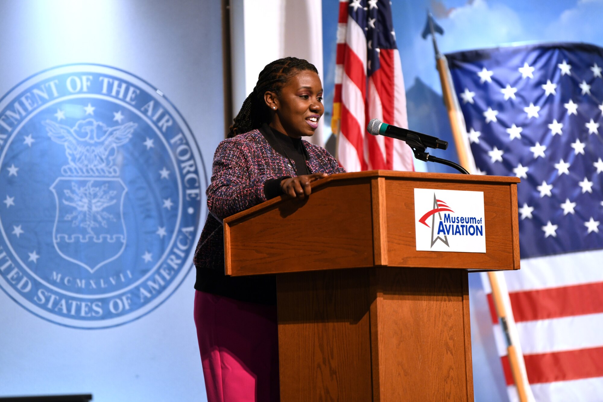 Woman standing behind podium, speaking