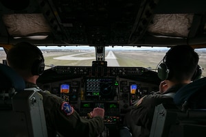 Pilots approach a runway to land a plane.