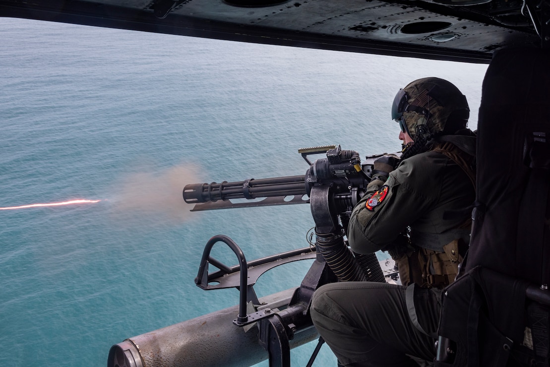 U.S. Marine Corps Gunnery Sgt. Parrish Hall II, a native of Michigan and a UH-1Y Venom crew chief with Marine Light Attack Helicopter Squadron (HMLA) 167, fires a GAU-17A minigun during a flight over the coast of North Carolina, March 26, 2024. HMLA-167 conducted precision-guided munitions delivery to familiarize designated pilots and ordnance personnel with proper procedures for firing and handling multiple ordnance types. The live-fire training allowed HMLA-167 to enhance integration with the joint force while training in aviation operations in maritime-surface warfare.