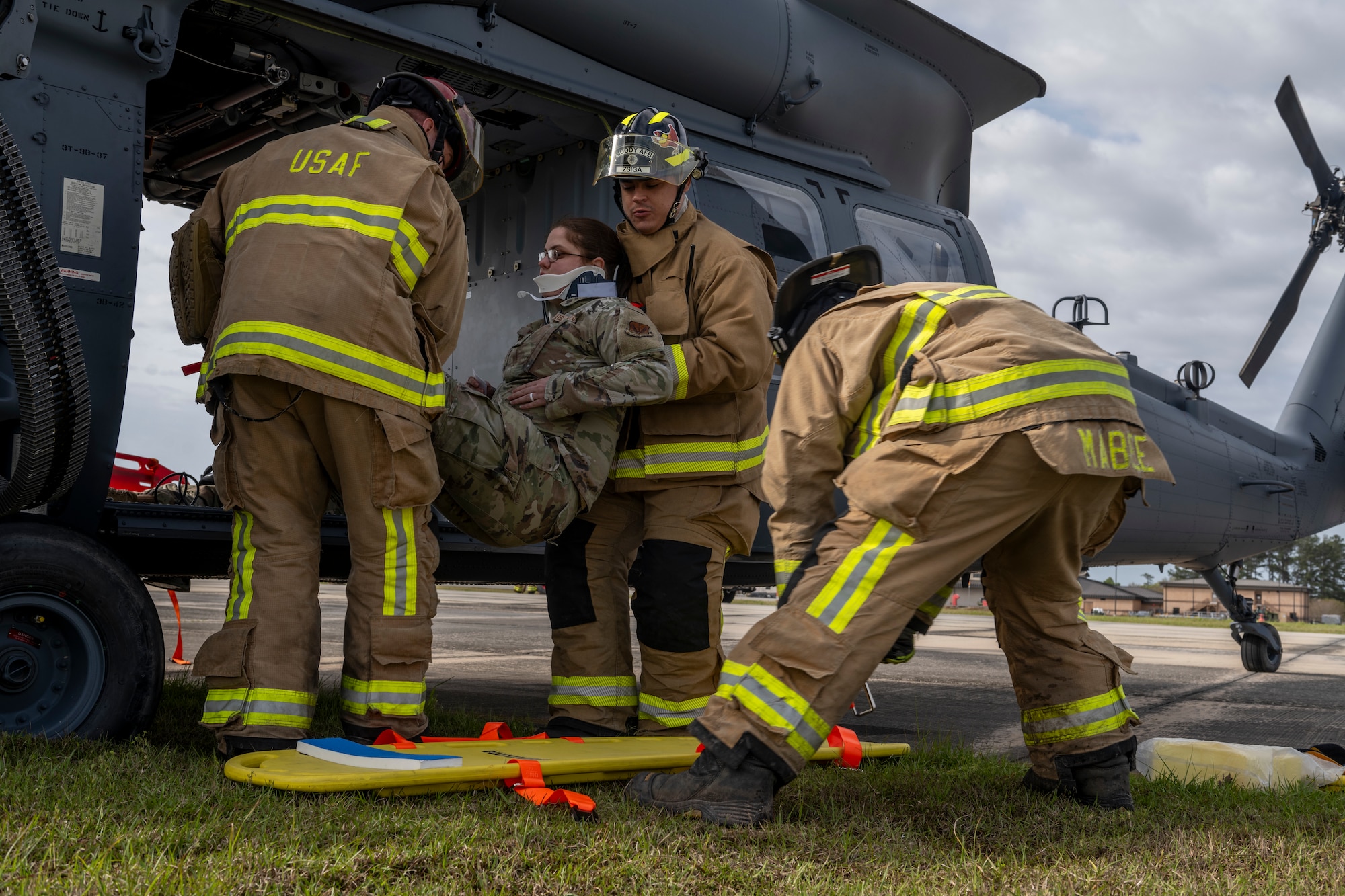 U.S. Air Force Airmen from the 23rd Civil Engineer Squadron Fire Department move a simulated patient during an aircraft accident response exercise at Moody Air Force Base, Georgia, March 26, 2024. First responders assessed the situation and provided triage to the patients, determining their required level of treatment. (U.S. Air Force photo by Senior Airman Deanna Muir)