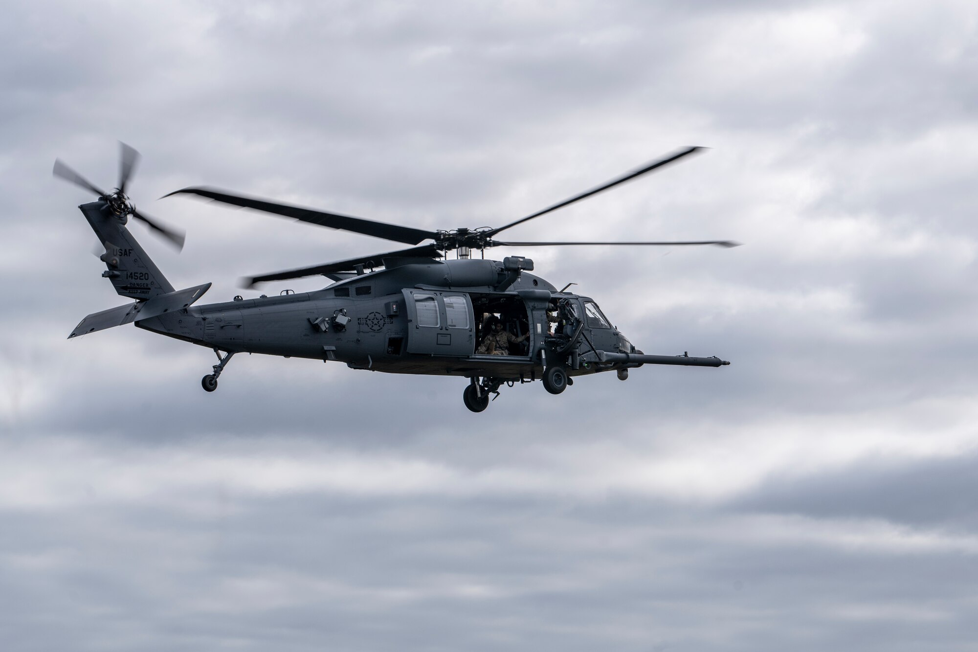 U.S. Air Force Airmen assigned to the 41st Rescue Squadron fly an HH-60W Jolly Green II over Moody Air Force Base, Georgia, March 26, 2024. The 41st RQS simulated an aircraft accident response exercise involving a hard landing. This exercise tested the communication and response of Moody AFB Airmen from various units across the 23rd Wing. (U.S. Air Force photo by Senior Airman Deanna Muir)