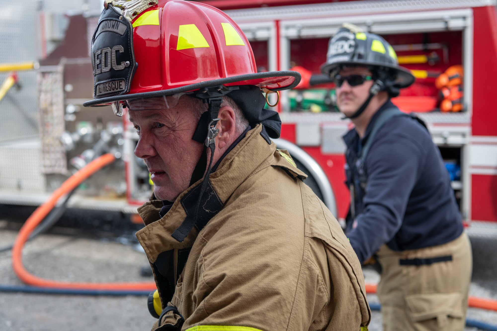 Firefighter Crew Chief James Brown, left, and firefighter Matthew Aussiker with Arnold Air Force Base Fire and Emergency Services use a handline to combat a blaze during live fire training Feb. 29, 2024, at Arnold Air Force Base, Tenn. Arnold FES crews participated in live fire structural fire training Feb. 27-29, 2024, and live aircraft fire training March 5-7, 2024. (U.S. Air Force photo by Keith Thornburgh)