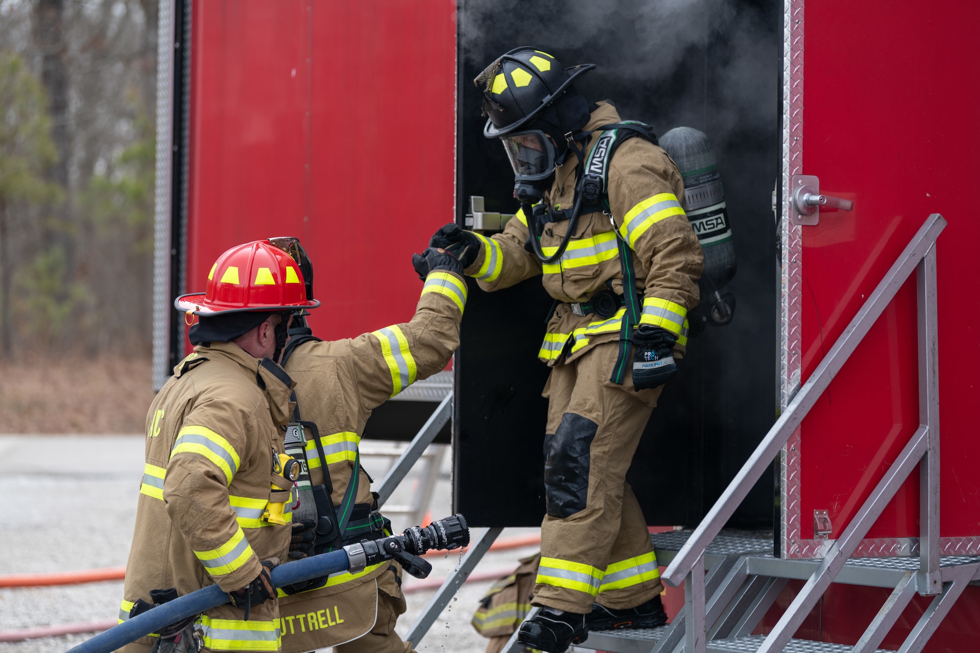 Arnold Engineering Development Complex Commander Col. Randel Gordon, right, receives a fist bump from an Arnold Air Force Base Fire and Emergency Services firefighter after taking part in structure fire training Feb. 29, 2024, at Arnold AFB, headquarters of AEDC. Arnold FES crews participated in fire structural fire training Feb. 27-29, 2024, and live aircraft fire training March 5-7, 2024. (U.S. Air Force photo by Keith Thornburgh)