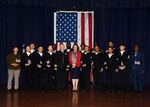 JOINT BASE SAN ANTONIO-FORT SAM HOUSTON – (March 27, 2024) – Capt. Jennifer Buechel, commanding officer, Naval Medical Research Unit (NAMRU) San Antonio, joined by Immigration Service Officer Yoli Fleming, with 15 service members from the U.S. Army, Navy, and Air Force who became U.S. citizens from the countries of China, Kenya, Jamaica, Nigeria, Vietnam, Venezuela, and The Philippines during a U.S. Citizenship Naturalization Oath Ceremony held at the Military and Family Readiness Center. Buechel, of Woodhaven, Mich., and a Navy nurse, delivered the keynote address.  NAMRU San Antonio’s mission is to conduct gap driven combat casualty care, craniofacial, and directed energy research to improve survival, operational readiness, and safety of Department of Defense (DoD) personnel engaged in routine and expeditionary operations.  It is one of the leading research and development laboratories for the U.S. Navy under the DoD and is one of eight subordinate research commands in the global network of laboratories operating under the Naval Medical Research Command in Silver Spring, Md. (U.S. Navy photo by Burrell Parmer, NAMRU San Antonio Public Affairs/Released)