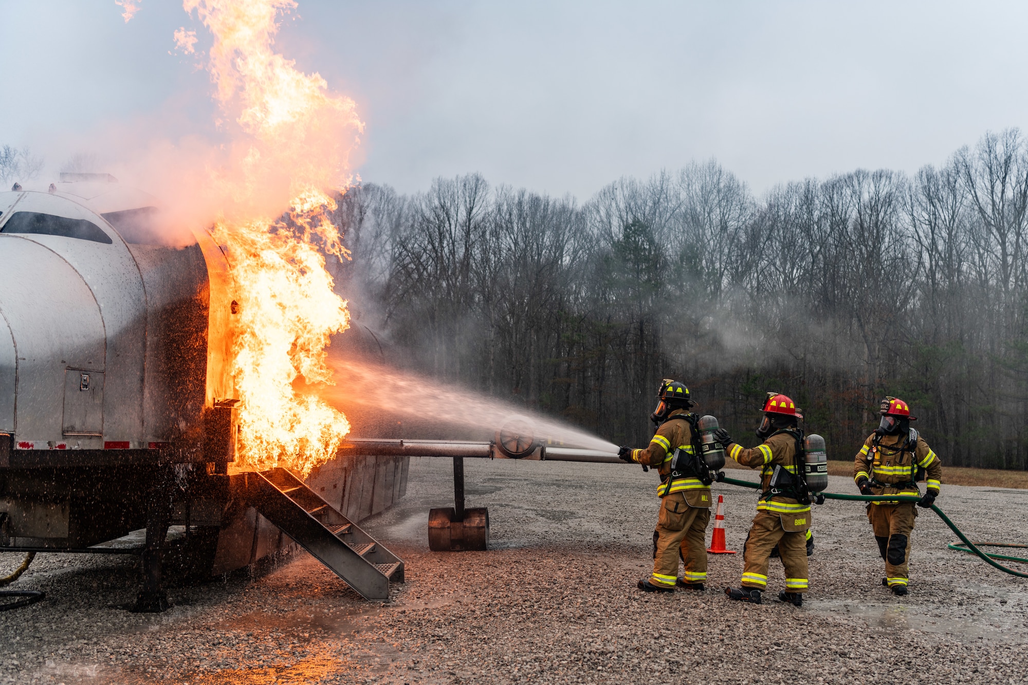 Arnold Air Force Base Fire and Emergency Services firefighters battle an exterior aircraft fire during fuselage fire training March 5, 2024, at Arnold AFB, Tenn., headquarters of Arnold Engineering Development Complex. Arnold FES crews took part in live structural fire training Feb. 27-29, 2024, and live aircraft fire training March 5-7, 2024. (U.S. Air Force photo by Keith Thornburgh)