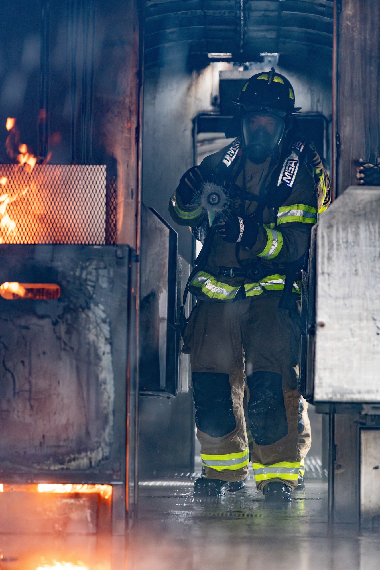 Arnold Engineering Development Complex Commander Col. Randel Gordon works to extinguish a fire during a fuselage fire training session March 5, 2024, at Arnold Air Force Base, headquarters of AEDC. Arnold AFB Fire and Emergency Services crews took part in live structural fire training Feb. 27-29, 2024, and live aircraft fire training March 5-7, 2024. (U.S. Air Force photo by Keith Thornburgh)