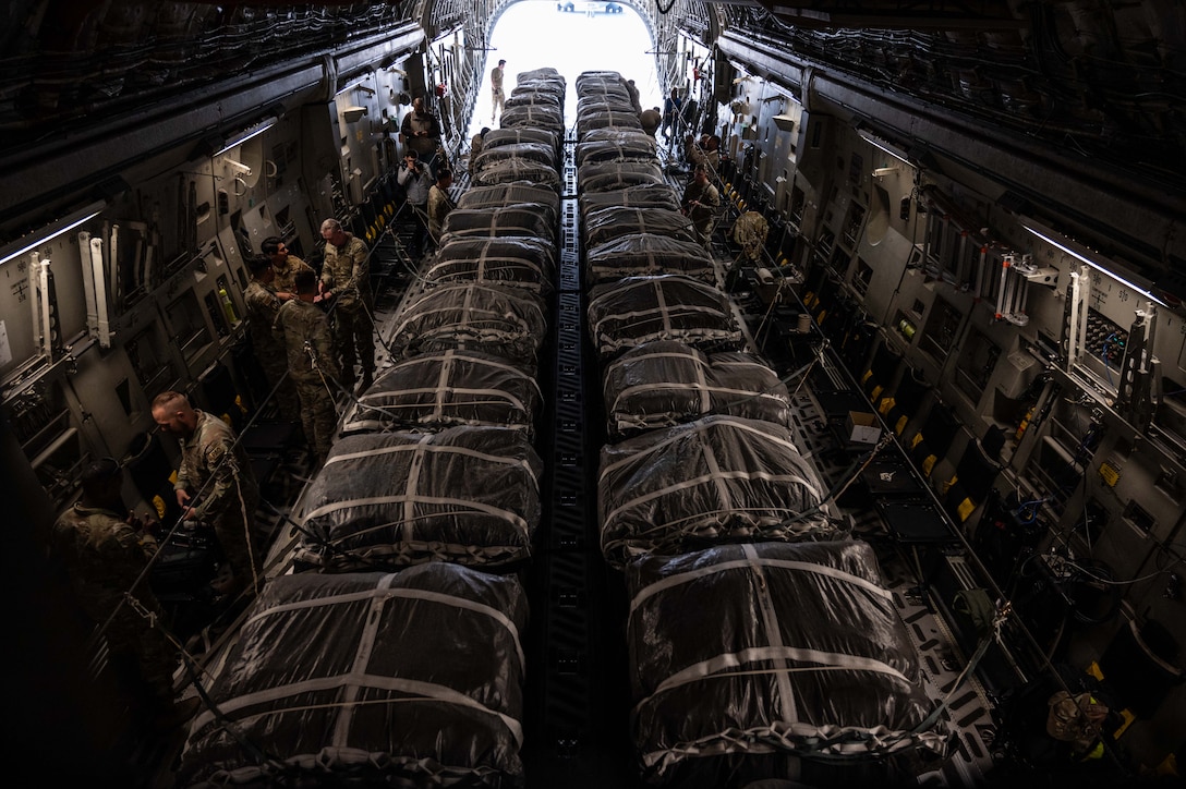 .S. Soldiers and Airmen secure 40 bundles of humanitarian aid onto an Air Mobility Command C-17 Globemaster III March 29, 2024, at an undisclosed location within the U.S. Central Command area of responsiblity. The U.S. has prioritized the delivery of humanitarian aid to relieve the suffering of civilians affected by the ongoing crisis in Gaza. The U.S. Air Force’s rapid global mobility capability enabled the expedited movement of critical, life-saving supplies to Gaza. (U.S. Air Force photo)