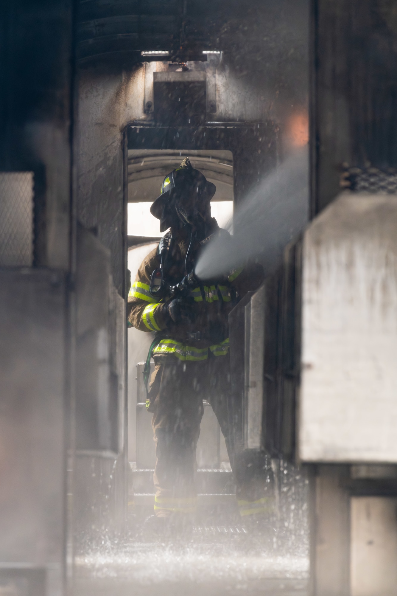 Arnold Engineering Development Complex Commander Col. Randel Gordon works to extinguish a fire during a fuselage fire training session March 5, 2024, at Arnold Air Force Base, headquarters of AEDC. Arnold AFB Fire and Emergency Services crews took part in live structural fire training Feb. 27-29, 2024, and live aircraft fire training March 5-7, 2024. (U.S. Air Force photo by Keith Thornburgh)