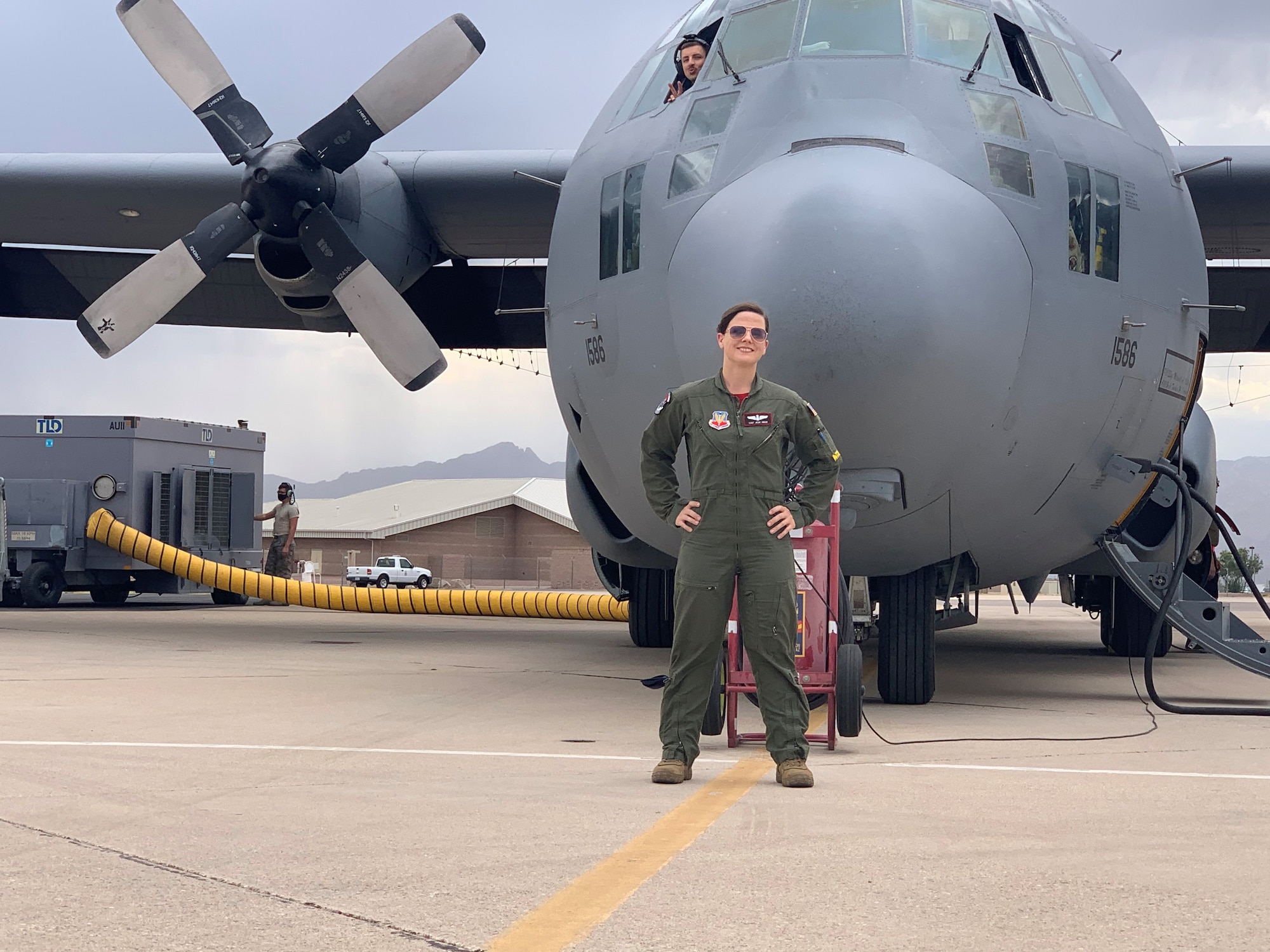 U.S. Air Force Master Sergeant Jessica Abad stands in front of the EC-130H Compass Call at Davis-Monthan Air Force Base, Arizona. Previously, Abad was assigned to Davis-Monthan, where she flew on the EC-130H. (Courtesy Photo)