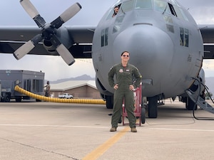 U.S. Air Force Master Sergeant Jessica Abad holds Air Education and Training Command’s new Torch Athena logo at Joint Base San Antonio-Lackland, Texas. Abad was recognized by U.S. Air Force Major General James Sears, Air Education and Training Command Deputy Commander for designing the new logo. (Courtesy Photo)