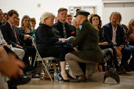 Brig. Gen. Troy Armstrong, the assistant adjutant general for the Nevada Army National Guard, presents the flag to Staff Sgt. Robert Garrison Brown's mother at Clark County Armory in Las Vegas, Nevada, March 24, 2024. Soldiers from the 1st Squadron, 221st Cavalry, along with friends and family, gathered to honor the memory of Brown, who passed away on March 4th. (U.S. Army National Guard photo by Spc. Adrianne Lopez.)(Photo used tonal adjustments to enhance subject.)