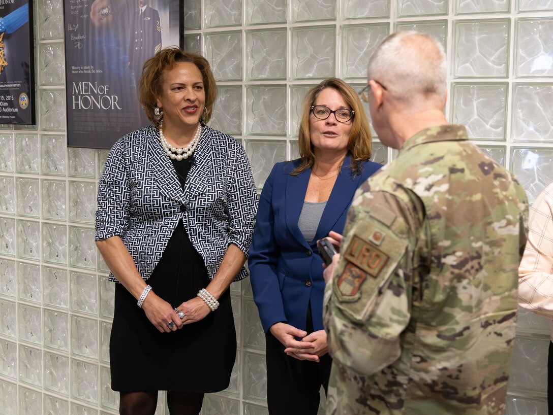 Debra White-Johnson and Rebecca Beck greet Air Force Col. Craig Lowery prior to the Women's History Month program.