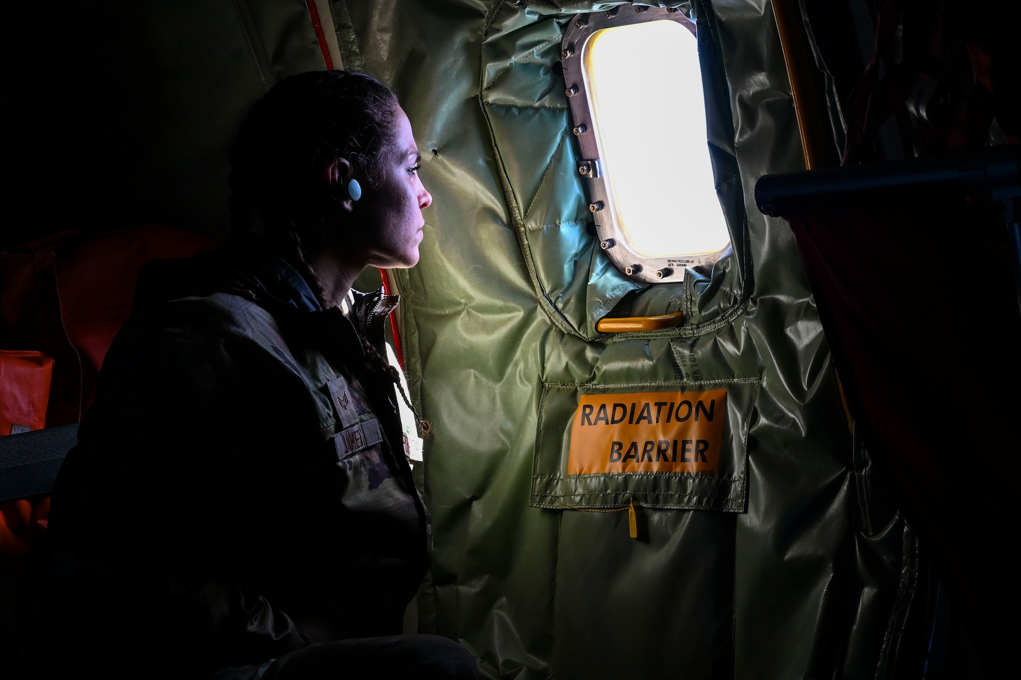Airman looks out KC-135 window