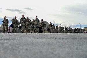 Airmen walk towards plane